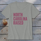 Light grey v-neck t-shirt with pink text "NORTH CAROLINA RAISED".