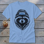 Light blue t-shirt with a black ink graphic of a raccoon wearing a beanie with mountains.