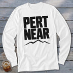 White long-sleeve t-shirt with black uppercase text reading PERT NEAR above a mountain range graphic.