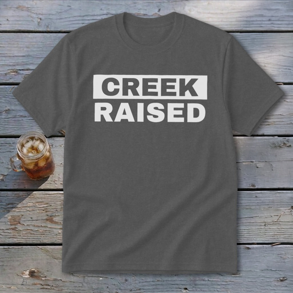 Dark gray t-shirt with white text reading "CREEK RAISED"