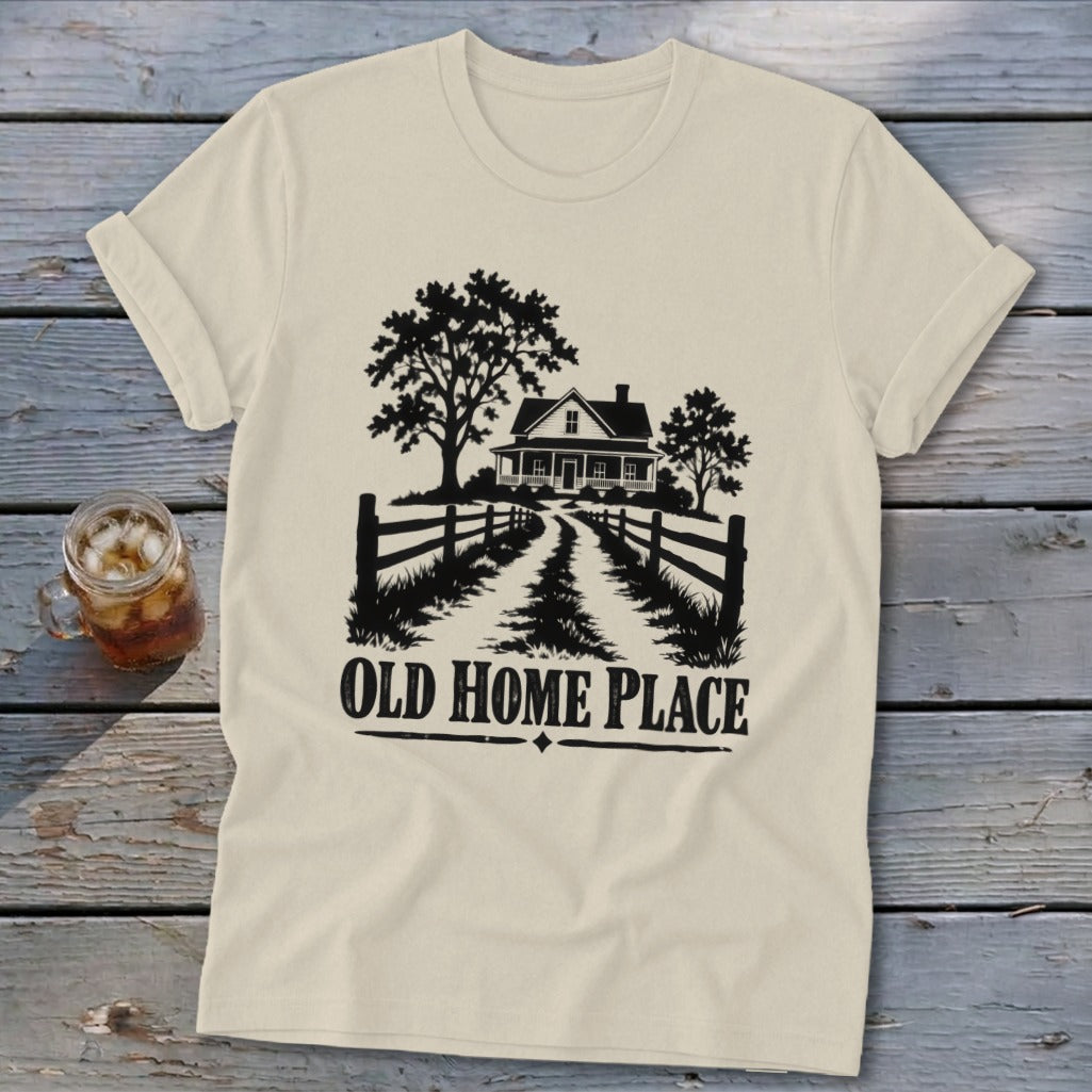 T-shirt with black graphic of a farmhouse, trees, and fence, saying "OLD HOME PLACE".