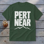 Dark green crewneck t-shirt featuring bold white text that reads PERT NEAR above a mountain outline.