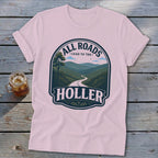 Pink t-shirt with "All Roads Lead to the Holler" graphic featuring a winding road through mountains.
