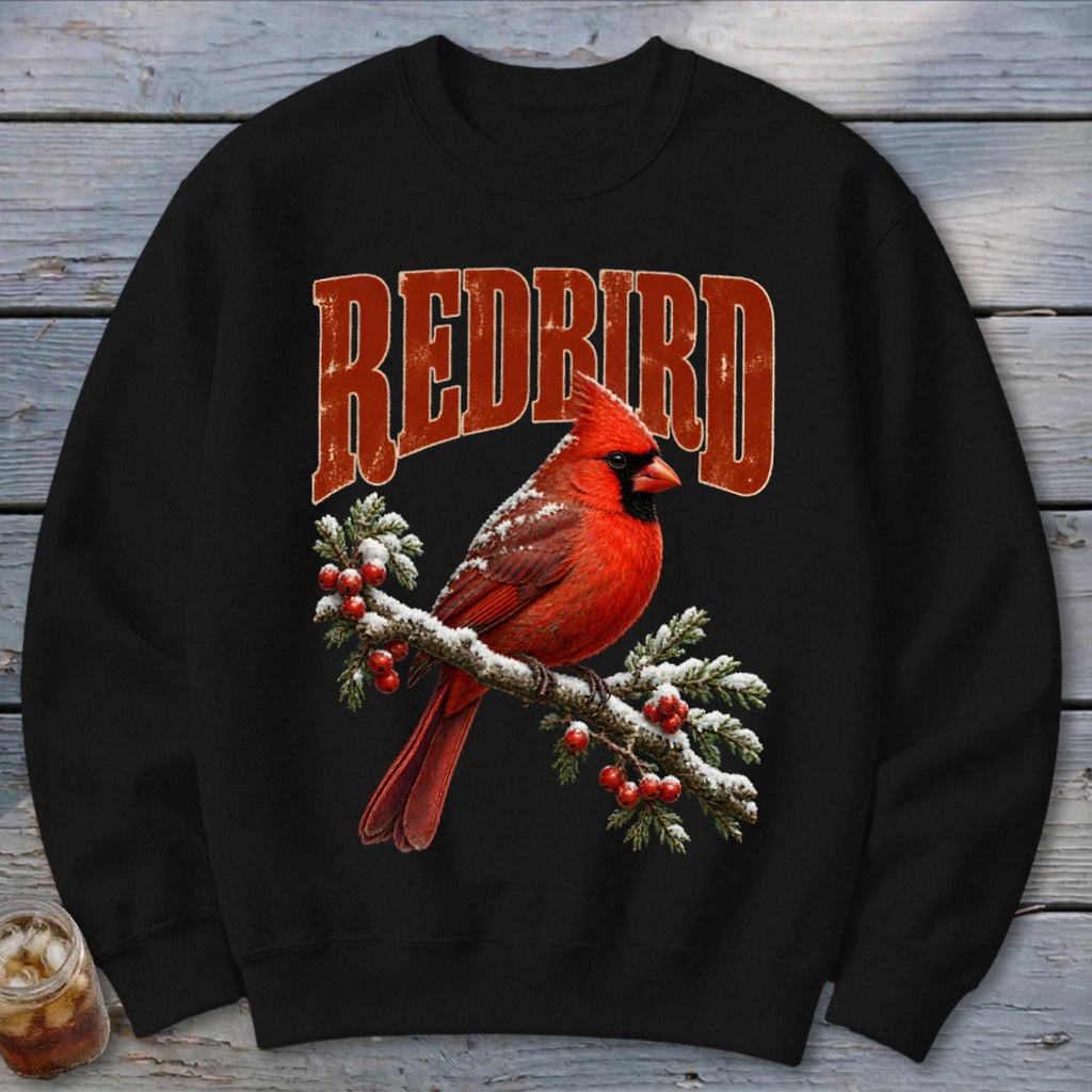 A black crewneck sweatshirt featuring a red cardinal on a snowy branch with the text "REDBIRD".