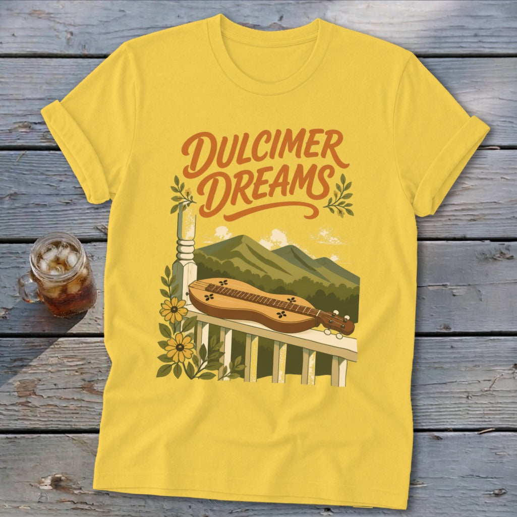 Yellow t-shirt with "Dulcimer Dreams" text, dulcimer, mountains, and flowers graphic.