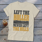 Cream t-shirt with text "LEFT THE HOLLER NEVER LEFT THE HILLS" and mountain graphic.
