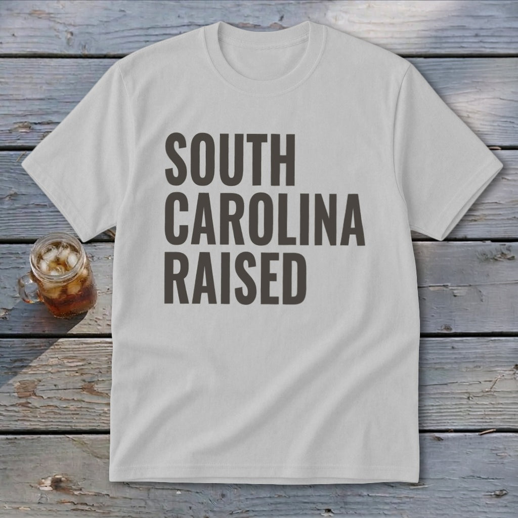 White t-shirt with "SOUTH CAROLINA RAISED" text in dark gray.