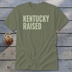 Olive green t-shirt with "Kentucky Raised" text.
