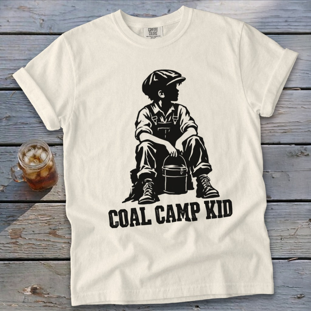Cream t-shirt with "COAL CAMP KID" text and silhouette of a seated boy with bucket.