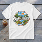 White t-shirt with circular North Carolina mountain landscape graphic and deer.