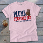 Pink t-shirt with "PLUMB TUCKERED OUT - AND IT AIN'T EVEN DINNER -" text.