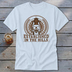 White t-shirt with a brown lantern graphic and text "ESTABLISHED IN THE HILLS".