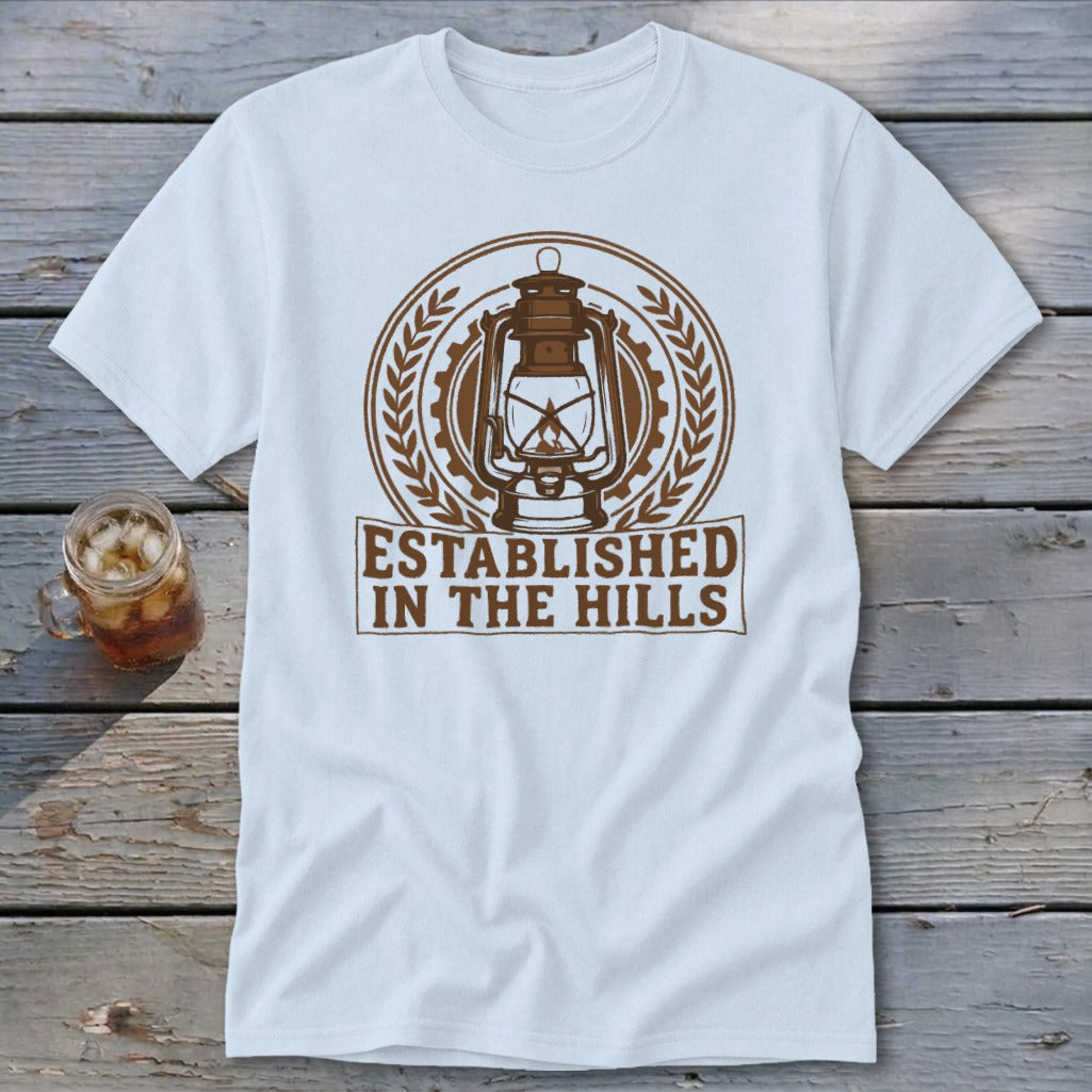 White t-shirt with a brown lantern graphic and text "ESTABLISHED IN THE HILLS".