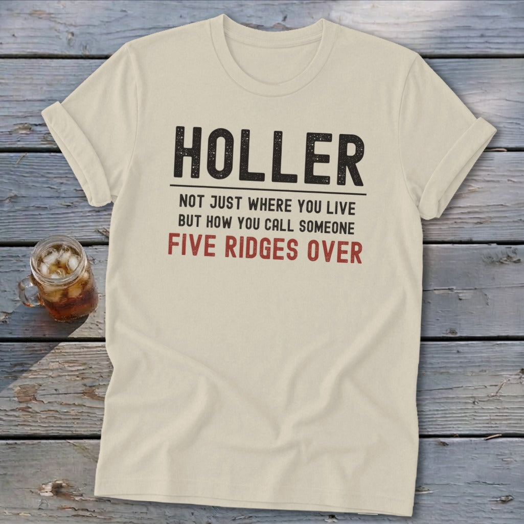 Cream t-shirt with "HOLLER NOT JUST WHERE YOU LIVE BUT HOW YOU CALL SOMEONE FIVE RIDGES OVER" text.