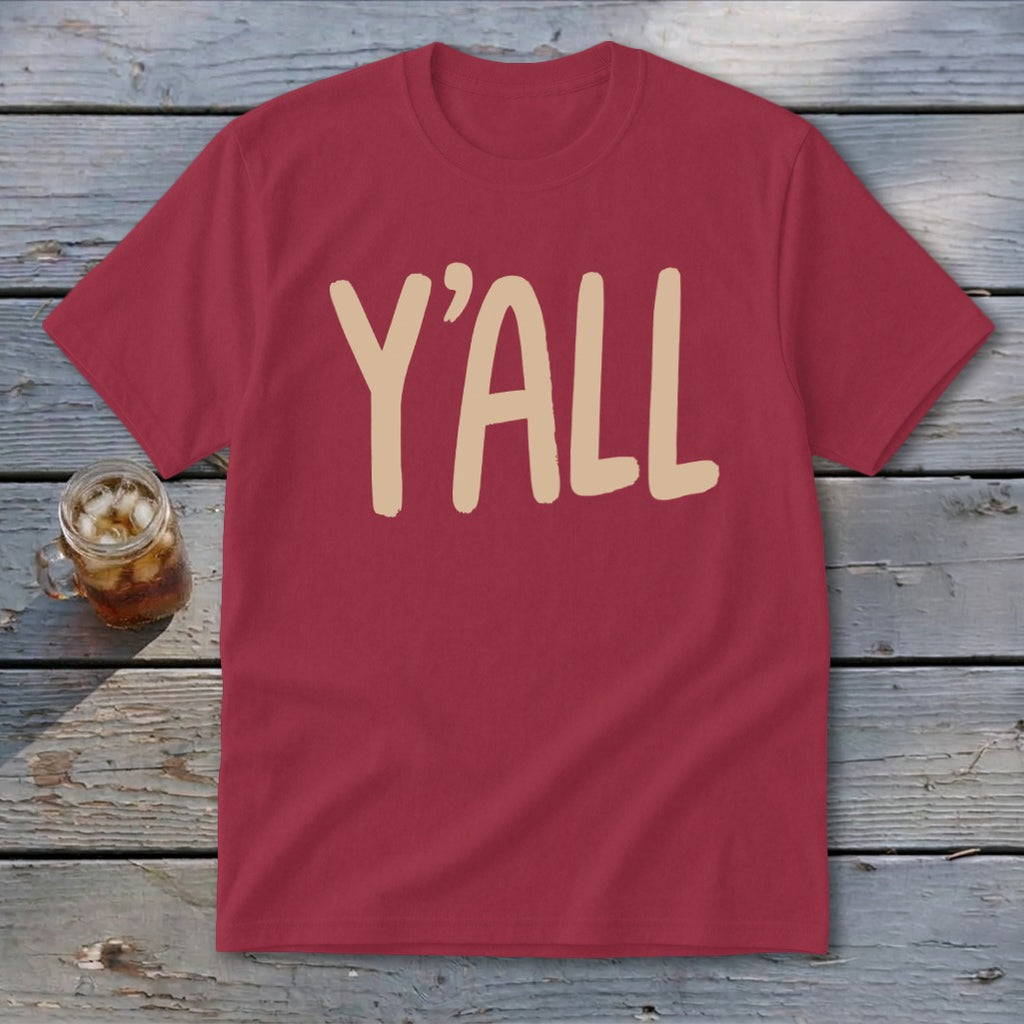 Maroon t-shirt with "Y'ALL" printed in beige on the front, next to a glass of iced tea.