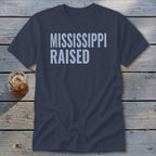 Dark blue t-shirt with "MISSISSIPPI RAISED" printed in light blue text.