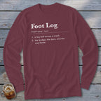 Maroon long-sleeve t-shirt with white dictionary-style text defining Foot Log laid across a wooden background.