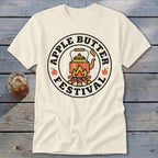 Cream t-shirt with circular graphic: "Apple Butter Festival" surrounding a teapot over a campfire.