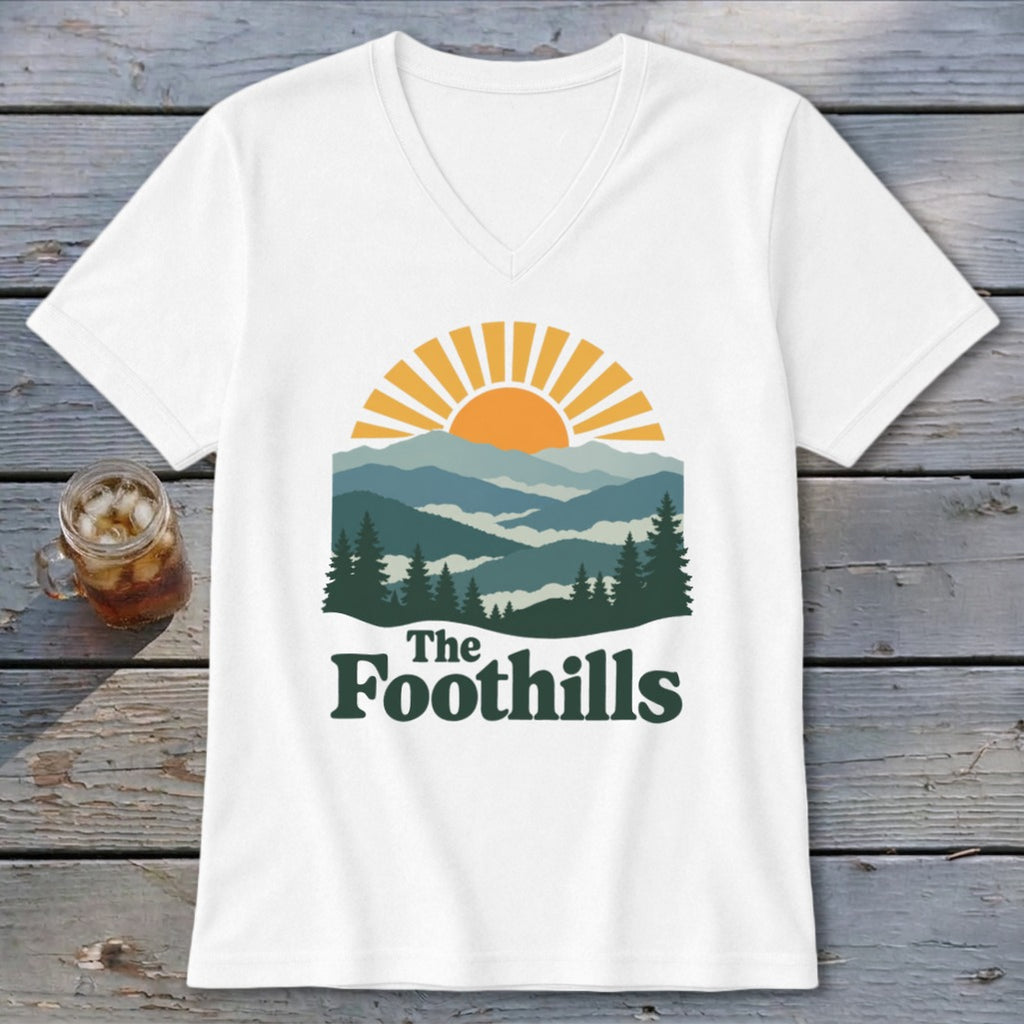 White t-shirt with "The Foothills" text over a mountain landscape graphic.