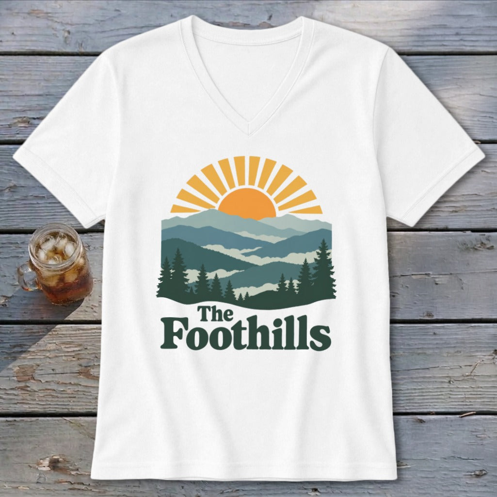 White t-shirt with "The Foothills" text over a mountain landscape graphic.