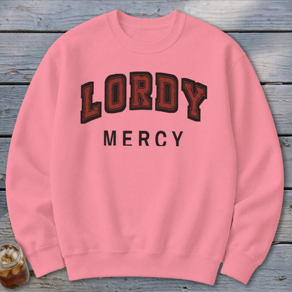 Pink crewneck sweatshirt with "LORDY MERCY" text in a collegiate font.