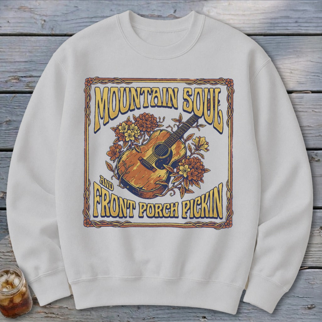 White sweatshirt with "Mountain Soul and Front Porch Pickin'" text and floral acoustic guitar graphic.