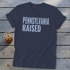 Navy t-shirt with white text reading "PENNSYLVANIA RAISED".