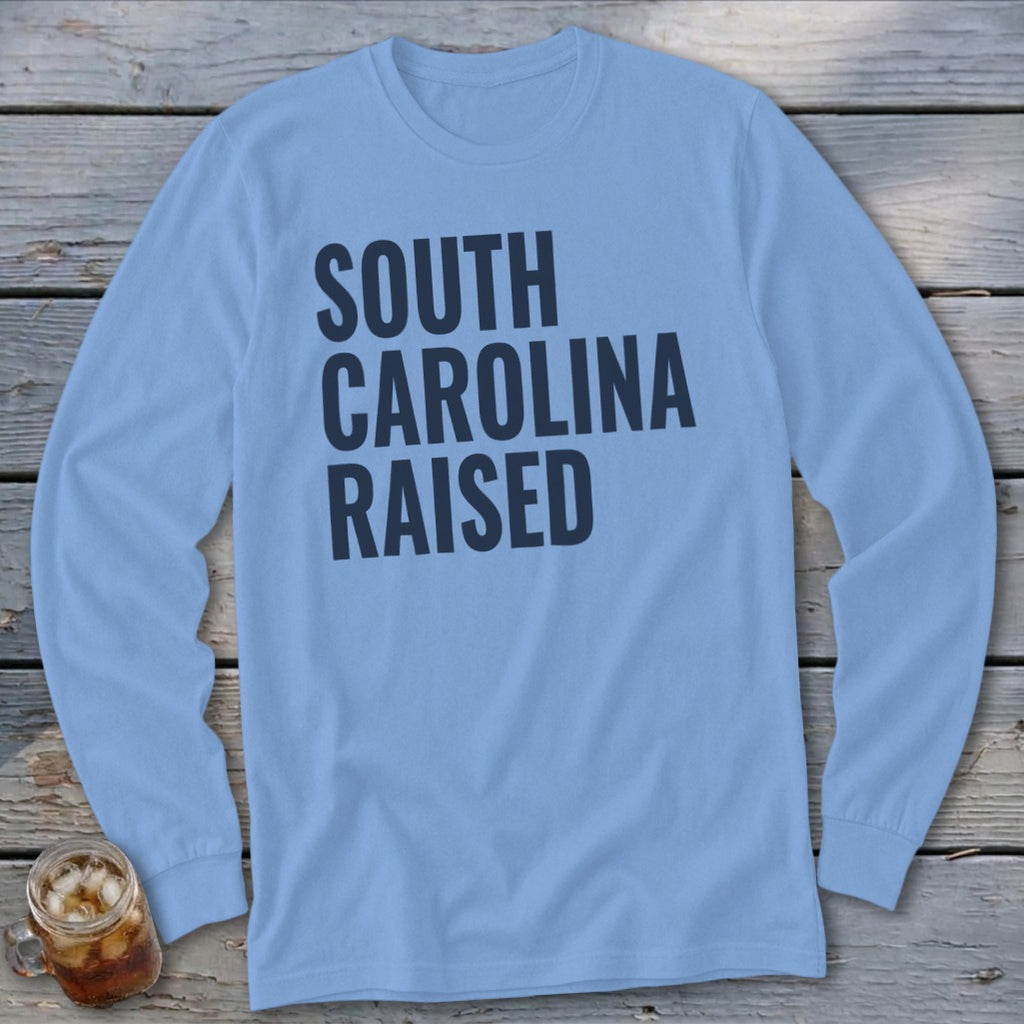 Light blue long-sleeve shirt with "South Carolina Raised" text in dark blue.