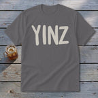 Gray t-shirt with "YINZ" text in a tan, brushstroke font.