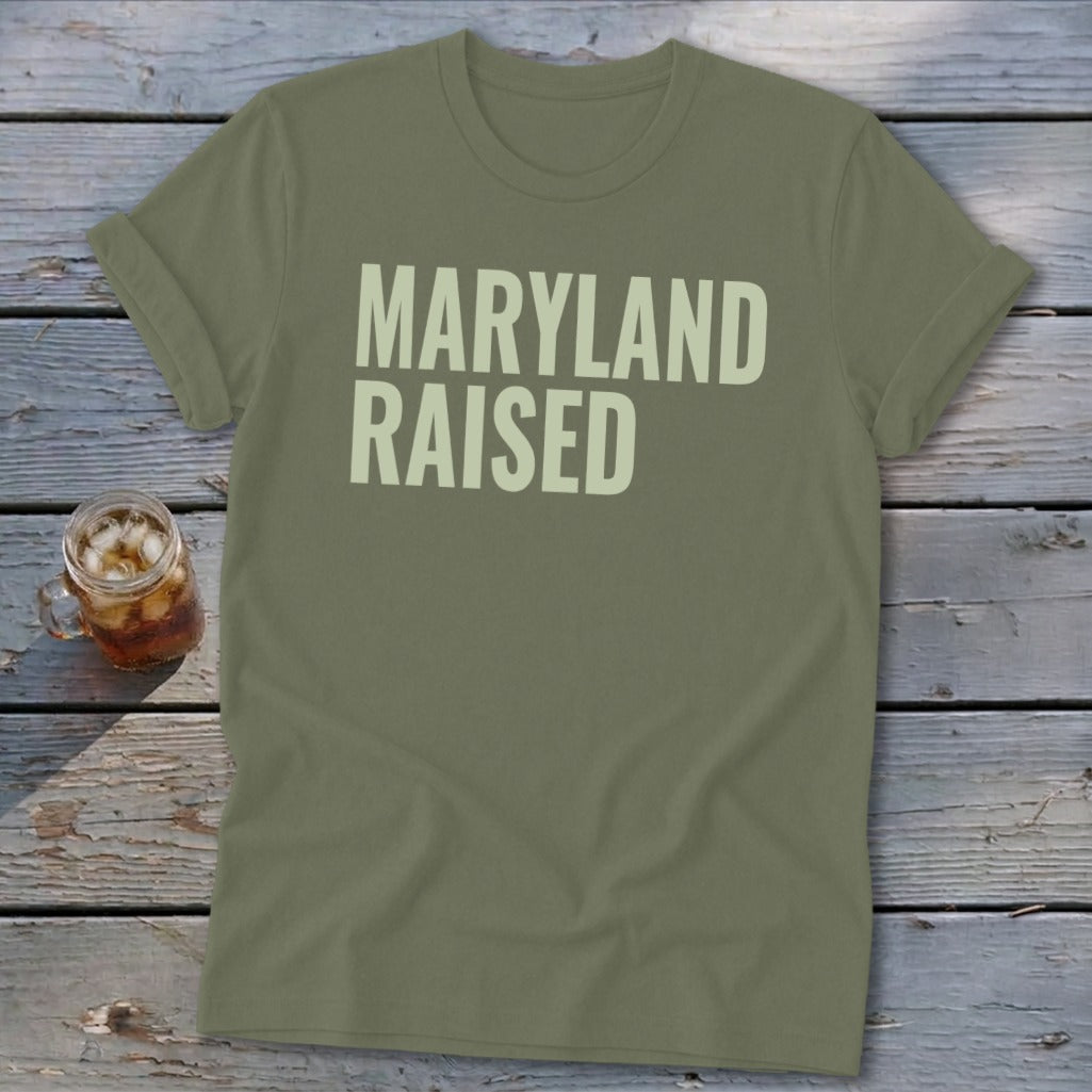 Olive green t-shirt with "Maryland Raised" in light cream text.