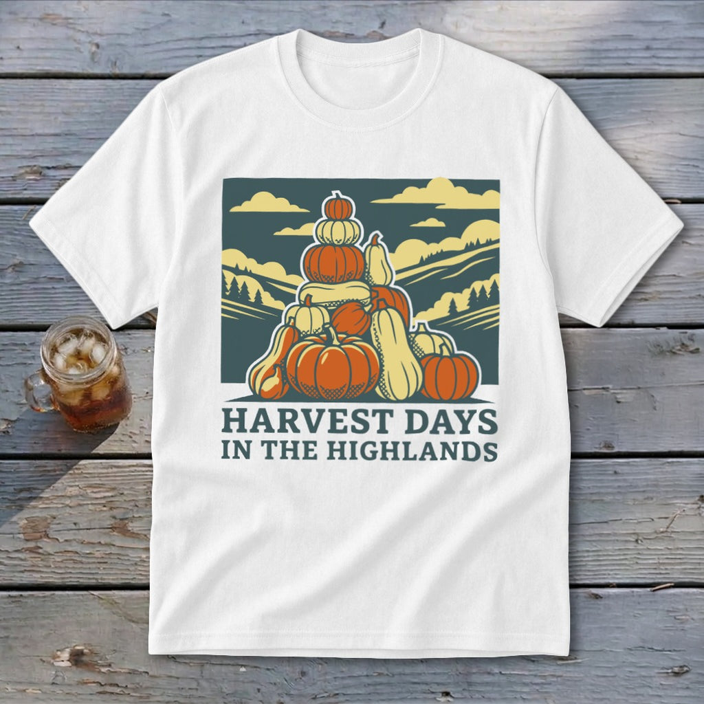White t-shirt featuring a retro graphic of a pumpkin stack and mountains with the text HARVEST DAYS IN THE HIGHLANDS.