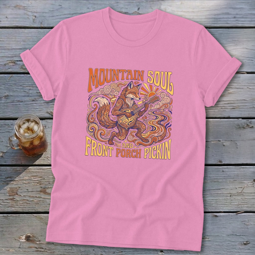 Pink t-shirt with a fox playing guitar and text "MOUNTAIN SOUL AND FRONT PORCH PICKIN'".
