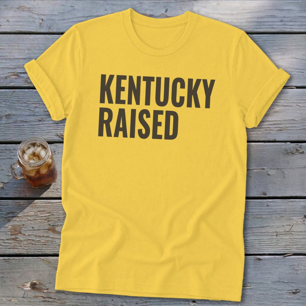 Yellow t-shirt with "KENTUCKY RAISED" text in dark gray.