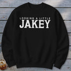 Black crewneck sweatshirt with white text "LOOKING A LITTLE JAKEY".