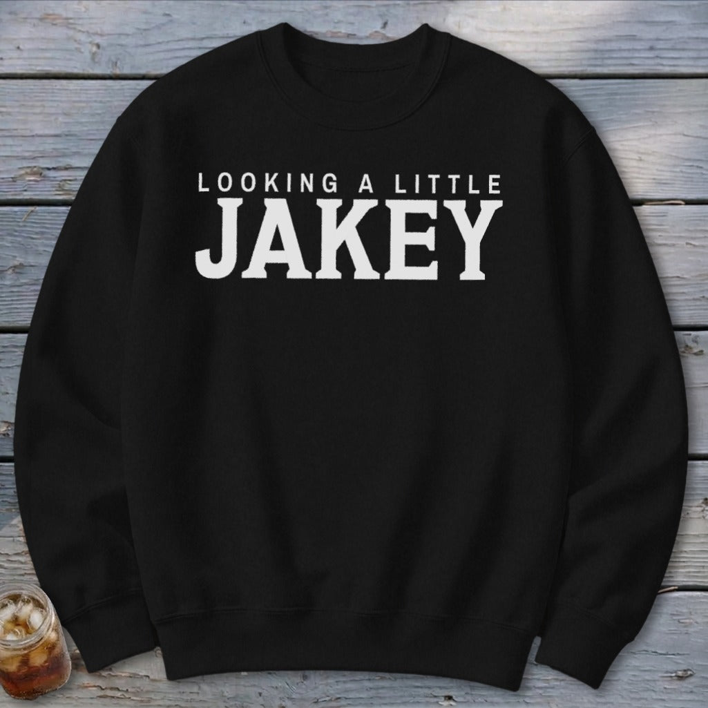 Black crewneck sweatshirt with white text "LOOKING A LITTLE JAKEY".