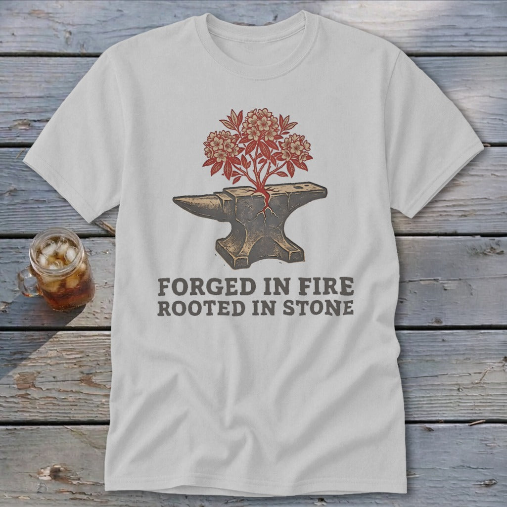 White t-shirt with anvil graphic, blooming flowers, and text "FORGED IN FIRE ROOTED IN STONE".