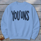 Light blue crewneck sweatshirt with dark blue "YOU'UNS" text.