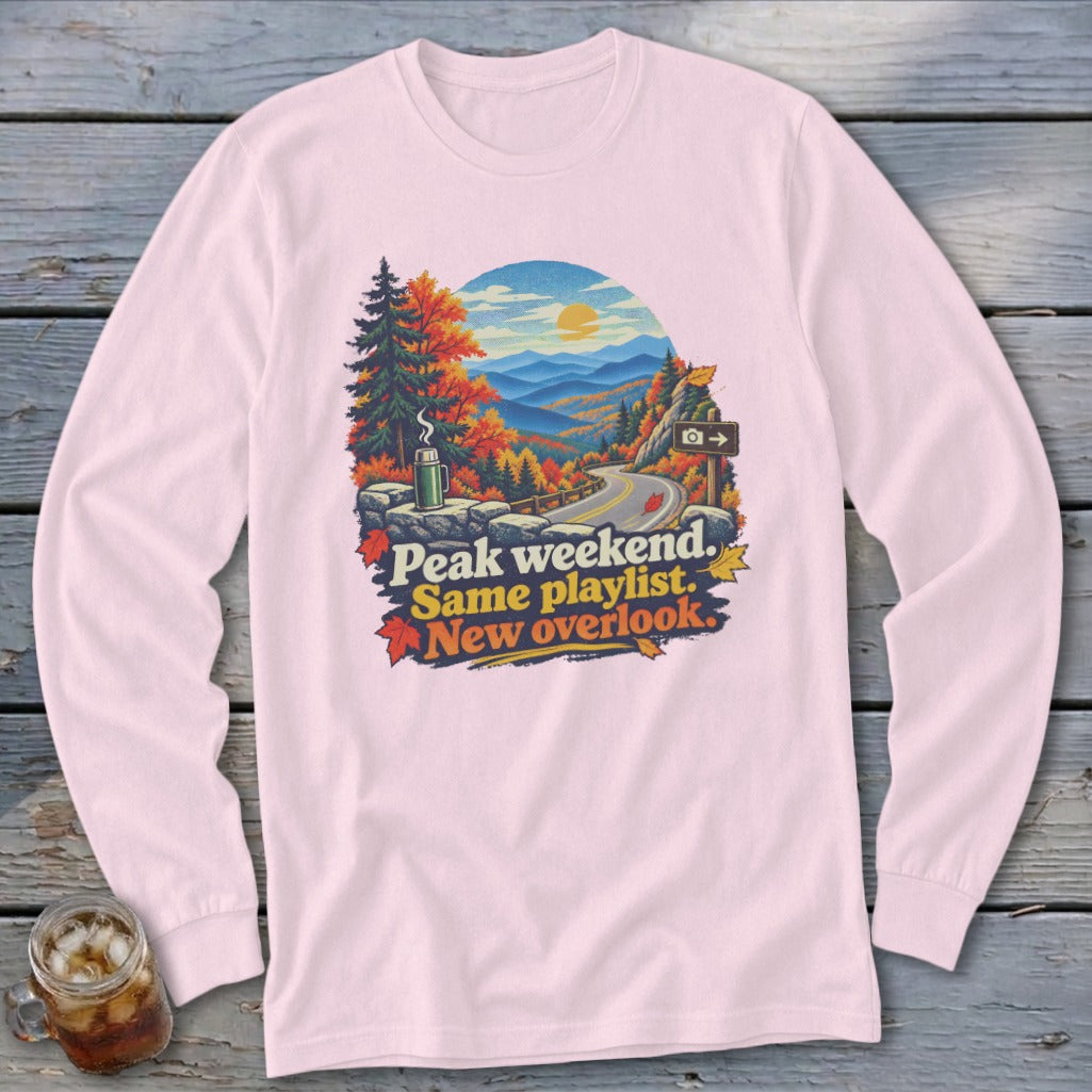 Pink long-sleeve shirt with autumn mountain landscape graphic and text.