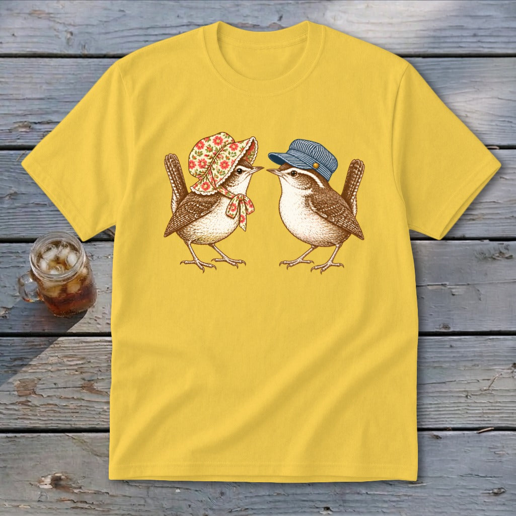 Yellow t-shirt with a graphic of two wrens, one wearing a bonnet and the other a cap.