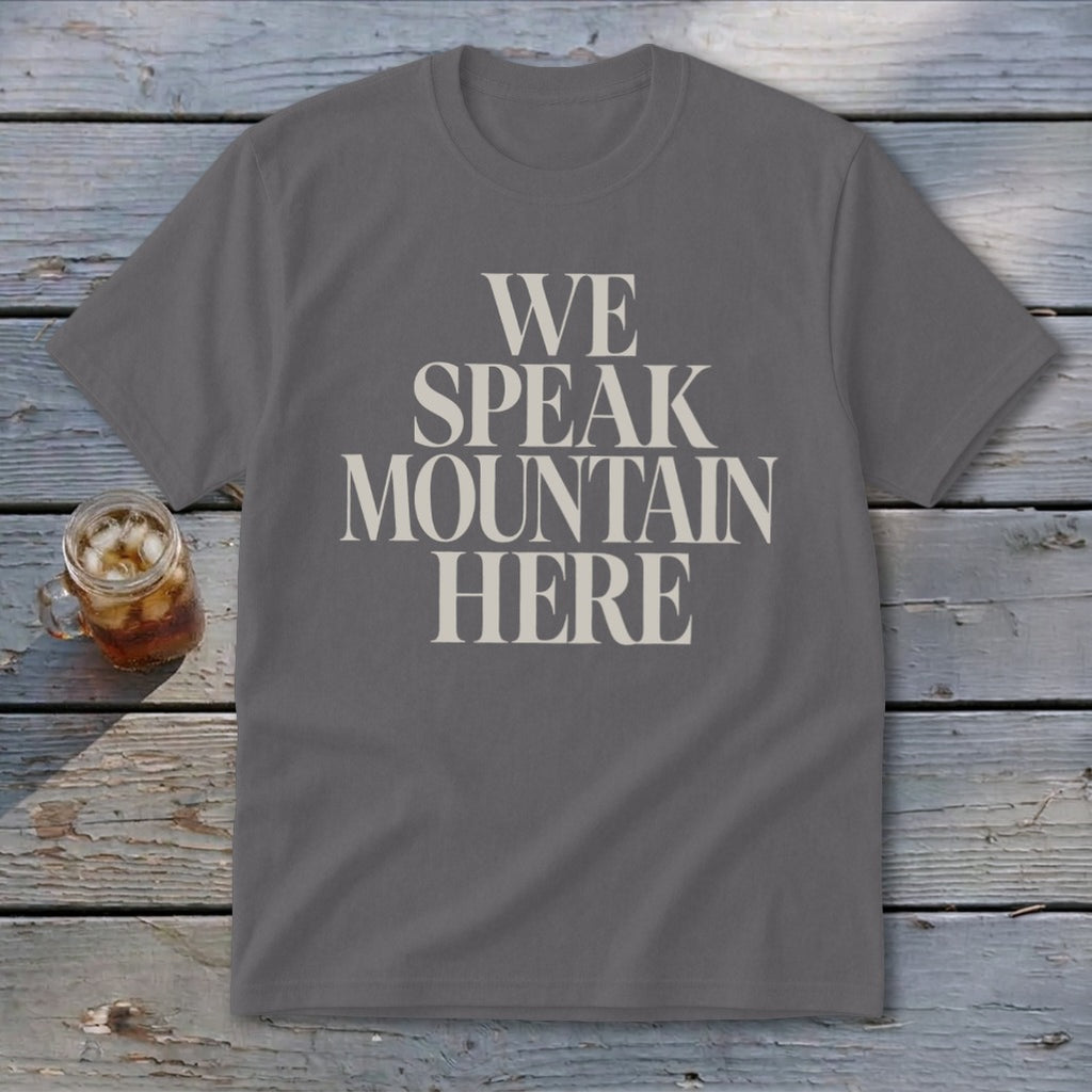 Gray t-shirt with "WE SPEAK MOUNTAIN HERE" text in cream color.
