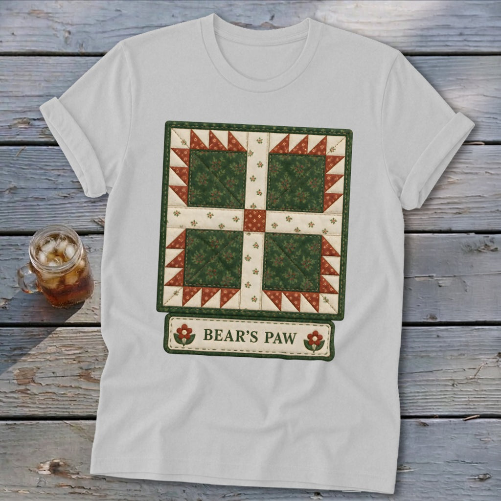 White t-shirt with a green and red quilt-style design labeled "BEAR'S PAW".