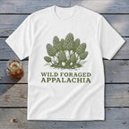 White t-shirt with green illustration of morel mushrooms and text "Wild Foraged Appalachia".