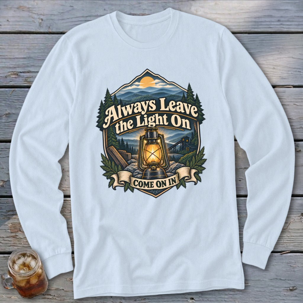 Long-sleeve shirt with "Always Leave the Light On, Come On In" graphic.