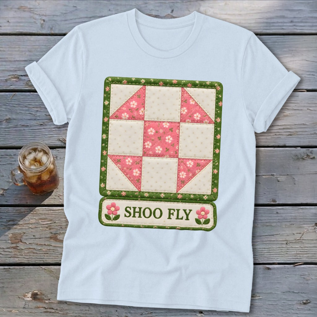 White t-shirt with a quilt design featuring a "Shoo Fly" block and text.