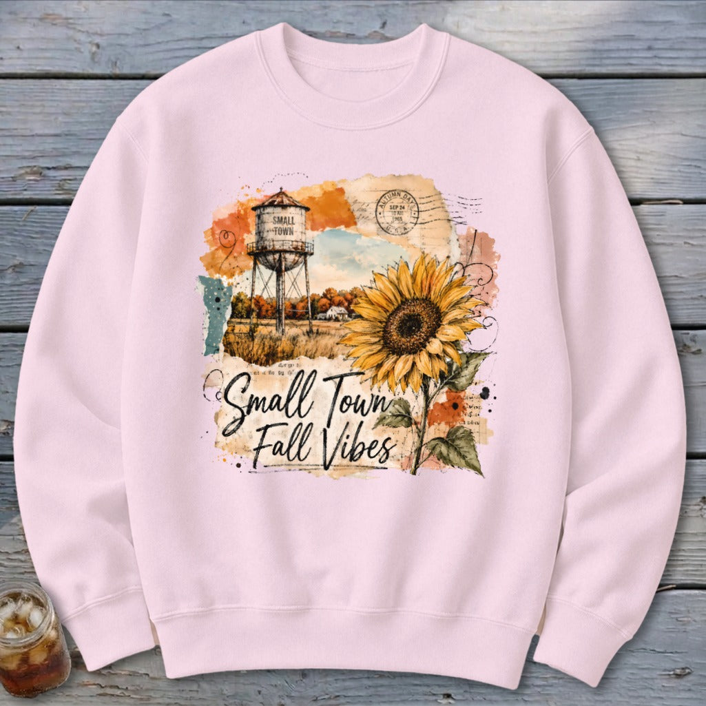 Crewneck sweatshirt with "Small Town Fall Vibes" design featuring a water tower and sunflower.