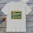 Light gray V-neck t-shirt featuring a green marquee sign graphic with the text Dinner on the Grounds.