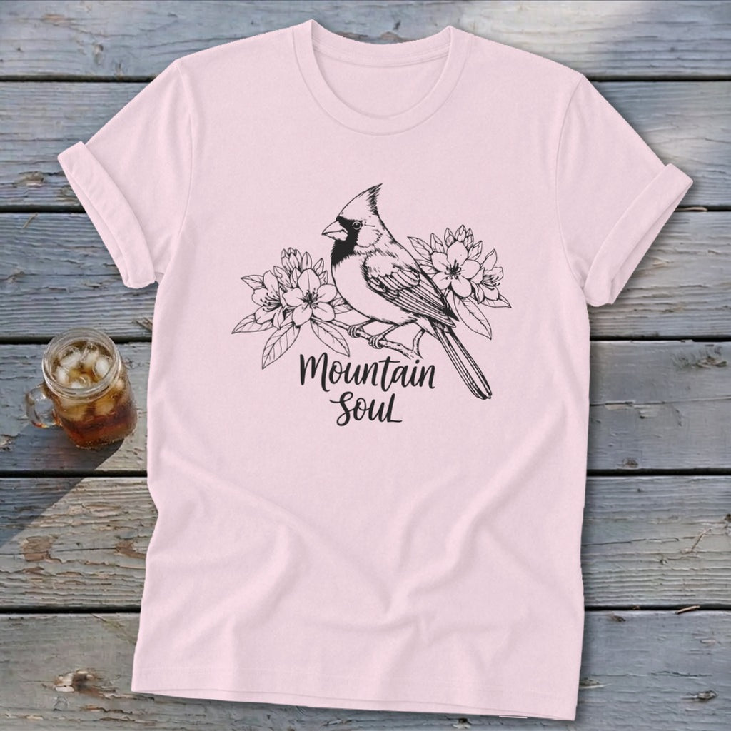 Light pink t-shirt with a black line drawing of a cardinal on a branch with flowers and "Mountain Soul" text.