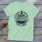 Light green t-shirt with "Appalachian Born and Bred Still Standing" text and graphics.