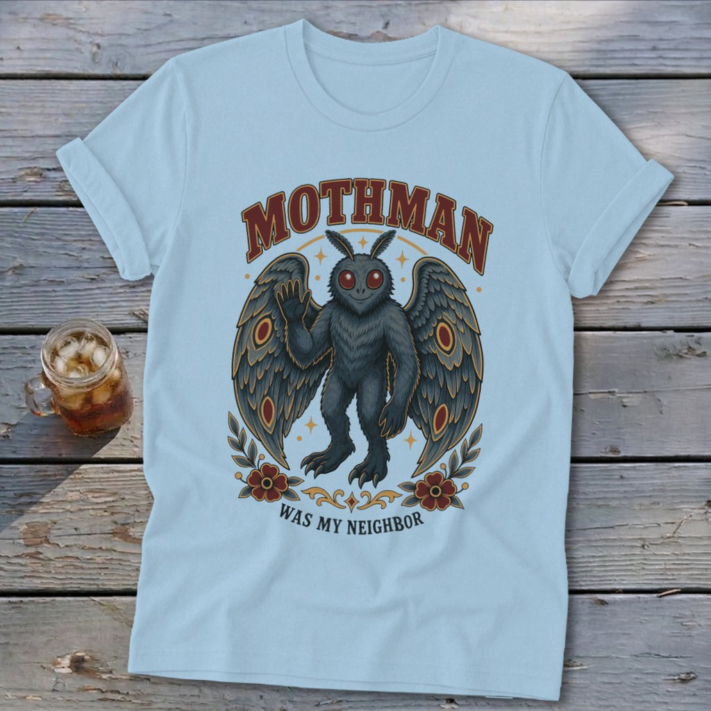 Light blue t-shirt with Mothman graphic and text "Mothman Was My Neighbor".