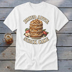 White t-shirt with a graphic of a stacked dried apple cake with apples and text.
